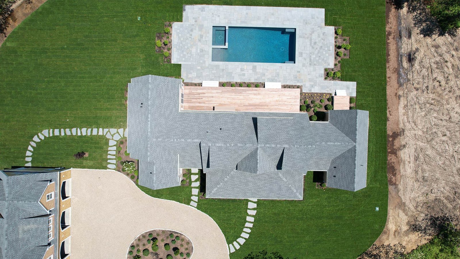 Top-down aerial of completed West Tisbury estate landscape — pool, circular drive, stepping stones, lawn — LandMasters Martha's Vineyard